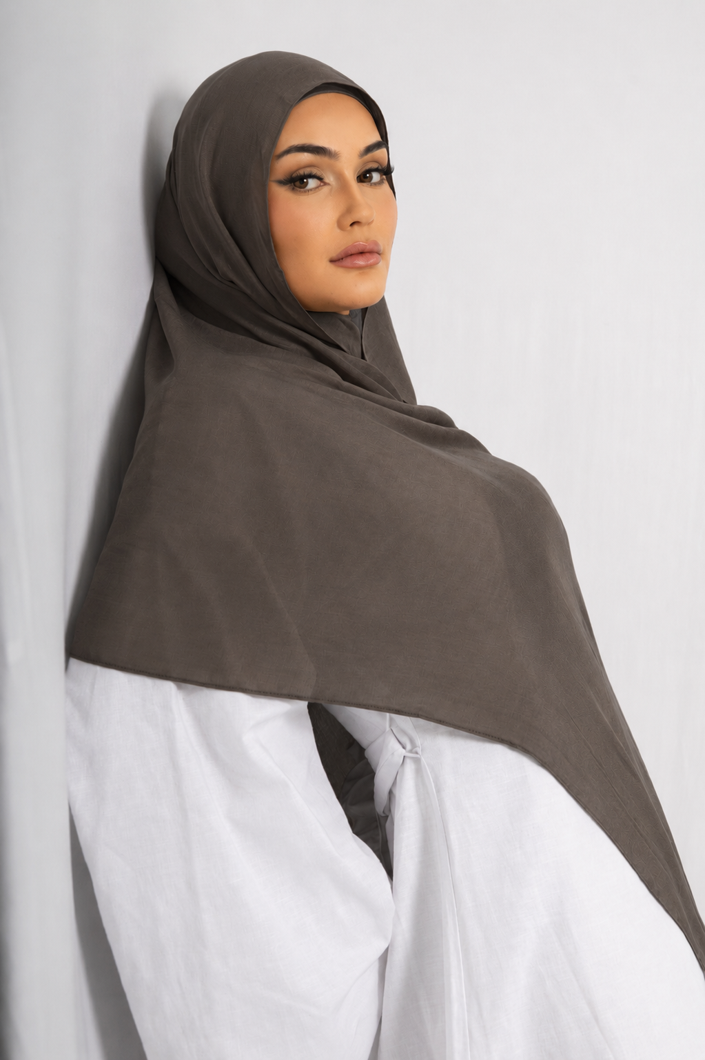 Front view of a woman wearing the Dark Truffle modal hijab, featuring a deep earthy brown shade, lightweight breathable fabric, and an elegant drape for modest everyday wear.
