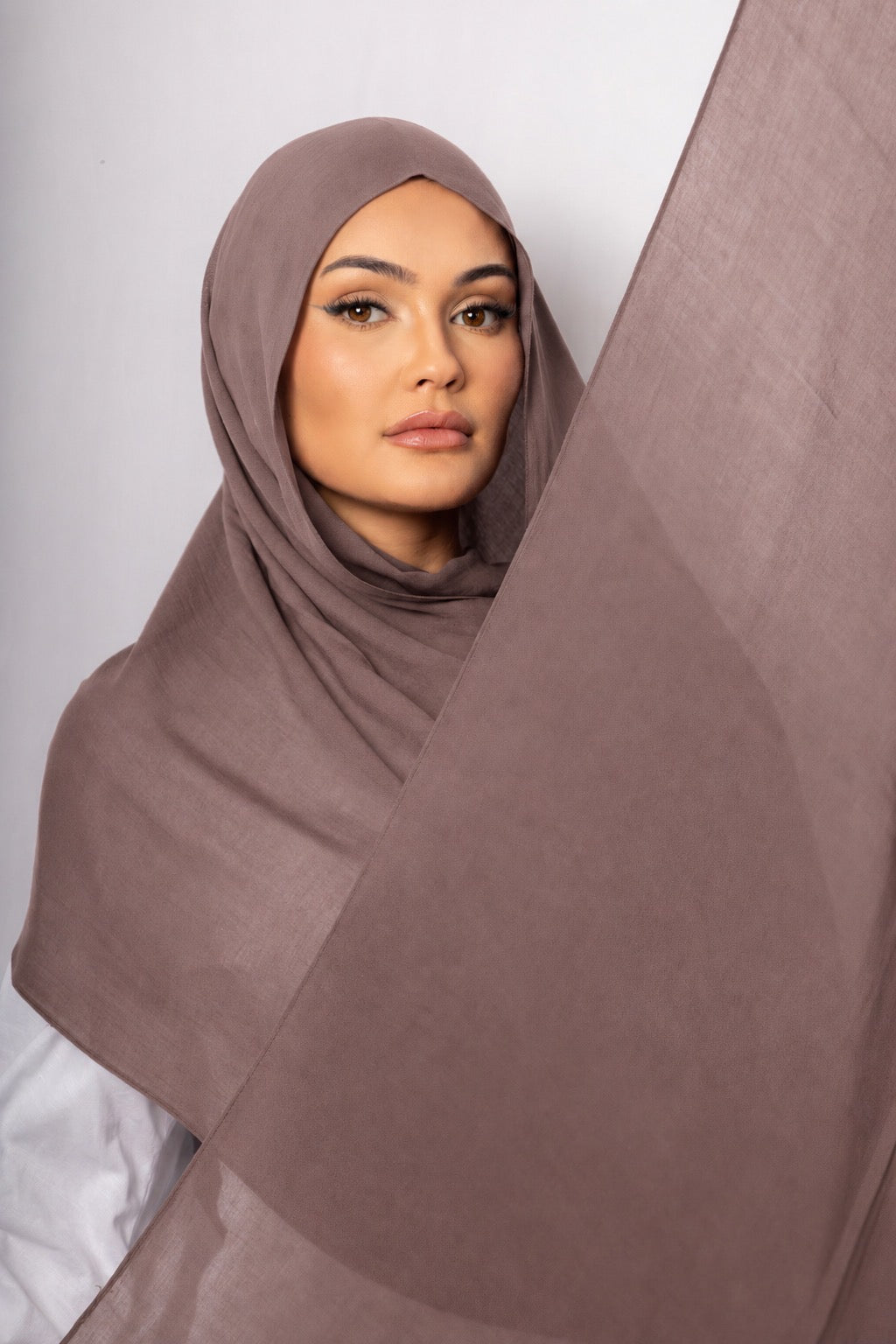 Close-up of a model wearing the Mauve Taupe modal hijab with flowing lightweight fabric, showcasing its soft muted taupe shade, breathable texture, and elegant drape for modest everyday styling