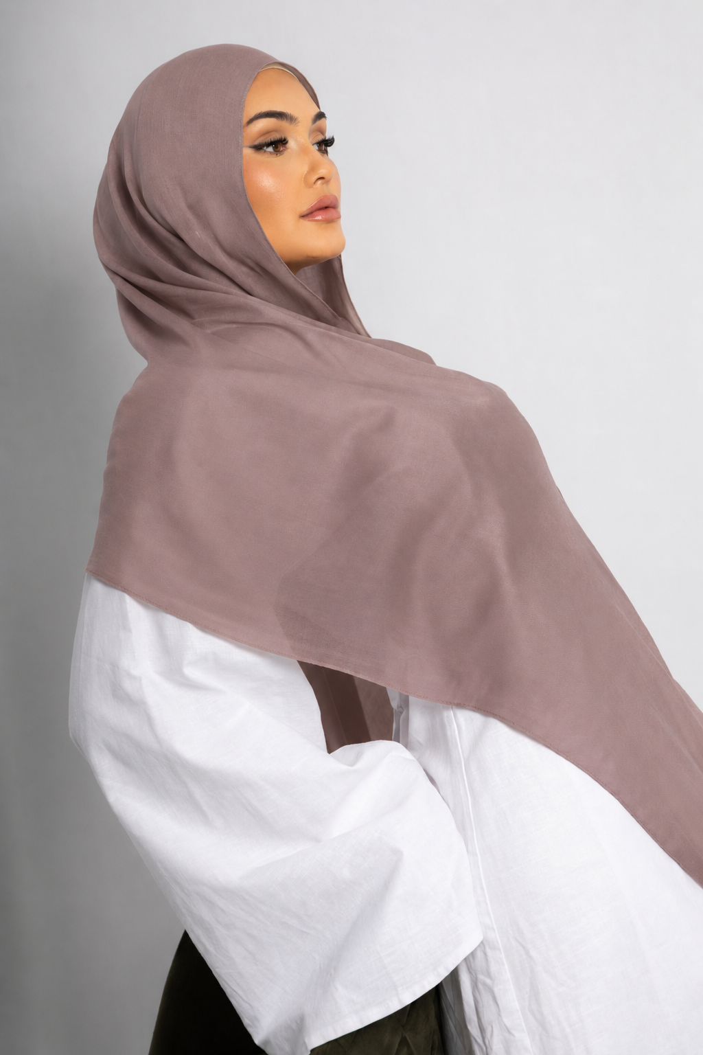 Side profile of a model wearing the Mauve Taupe modal hijab, showcasing its soft muted taupe color, lightweight breathable fabric, and elegant drape for modest everyday wear.