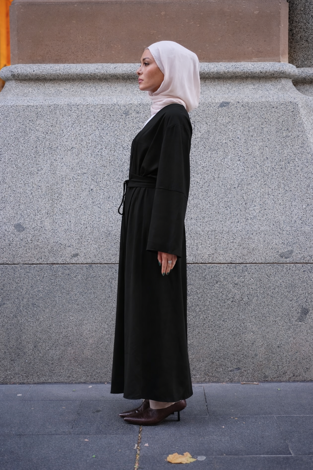 Rowan Belted Abaya in black by Orlena Official, side view of a full-length modest dress with a belted waist and hijab styling