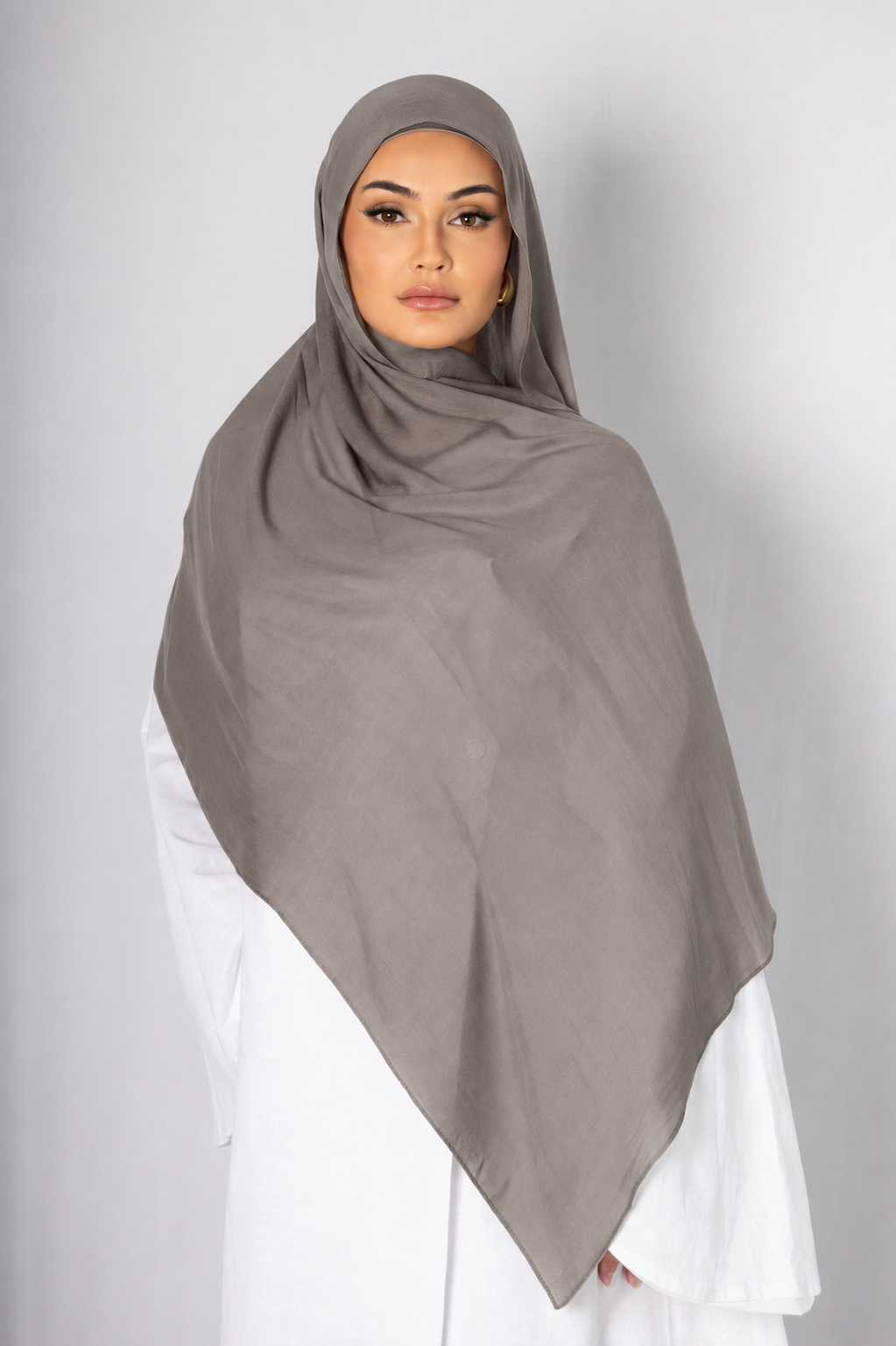 Front view of a model wearing the Stone Taupe modal hijab, featuring a soft stone taupe shade, lightweight breathable fabric, and an elegant drape for modest everyday styling