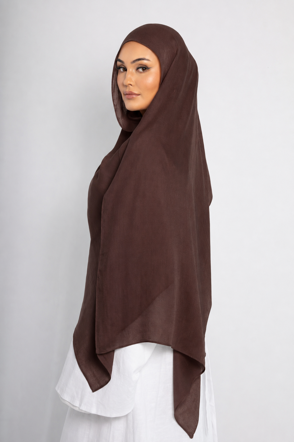 Side view of a woman wearing the Walnut Brown modal hijab, showcasing the rich brown colour, lightweight breathable fabric, and elegant full-length drape for modest wear