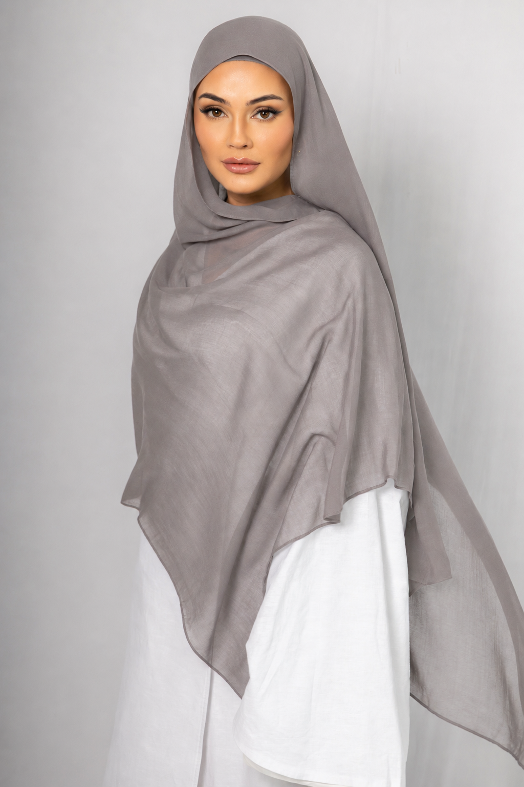 Front view of a woman wearing the Ash Taupe modal hijab, featuring a lightweight breathable fabric, elegant drape, and soft taupe colour for modest everyday wear