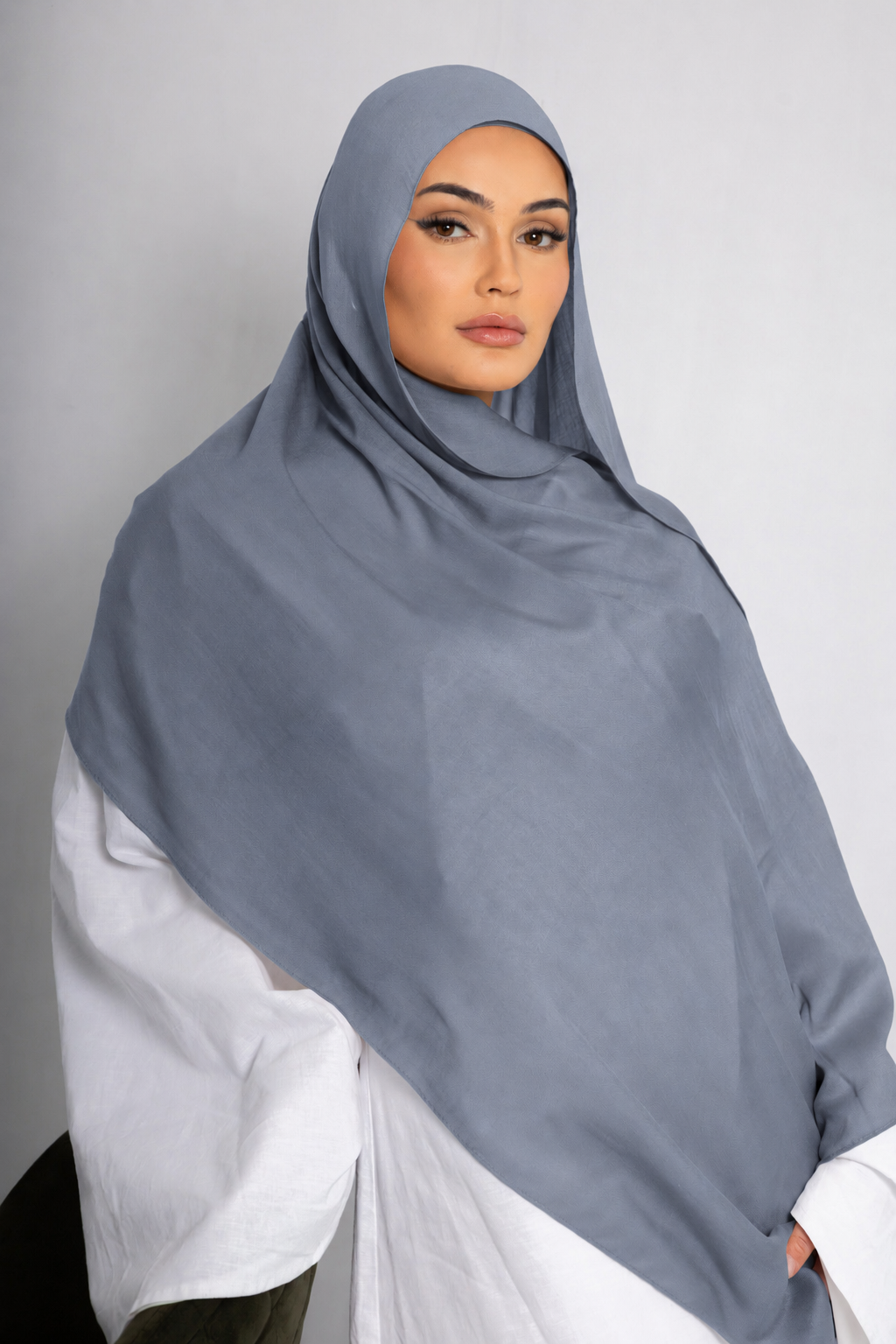 Front view of a woman wearing the Blue Haze modal hijab in a soft light blue shade, featuring a lightweight drape and elegant modest styling