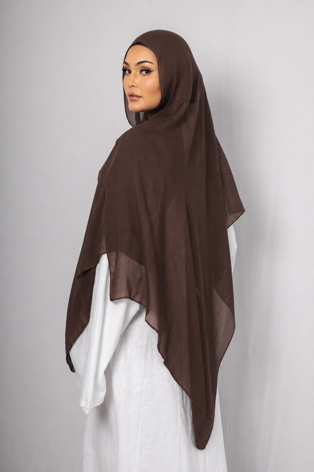 Back view of a woman wearing the Chocolate Brown modal hijab, showcasing the rich chocolate brown colour, lightweight breathable fabric, and elegant flowing drape for modest wear
