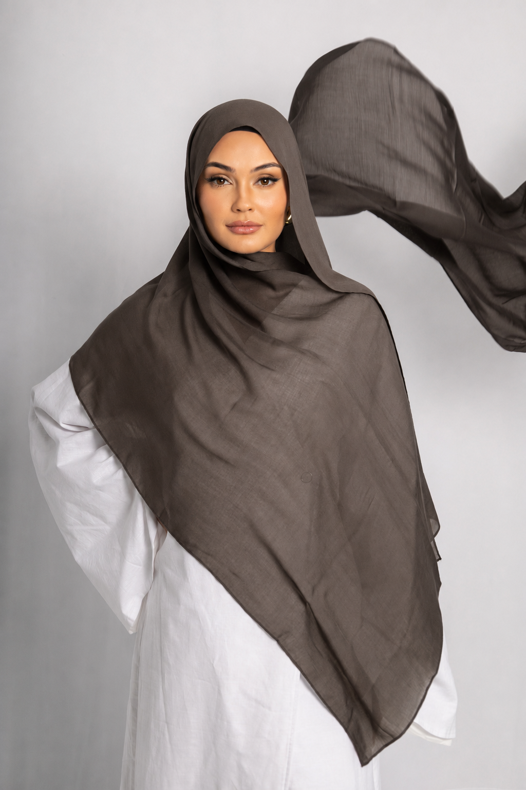 Model wearing the Dark Truffle modal hijab with flowing lightweight fabric, showcasing its breathable texture, elegant drape, and rich earthy brown tone.
