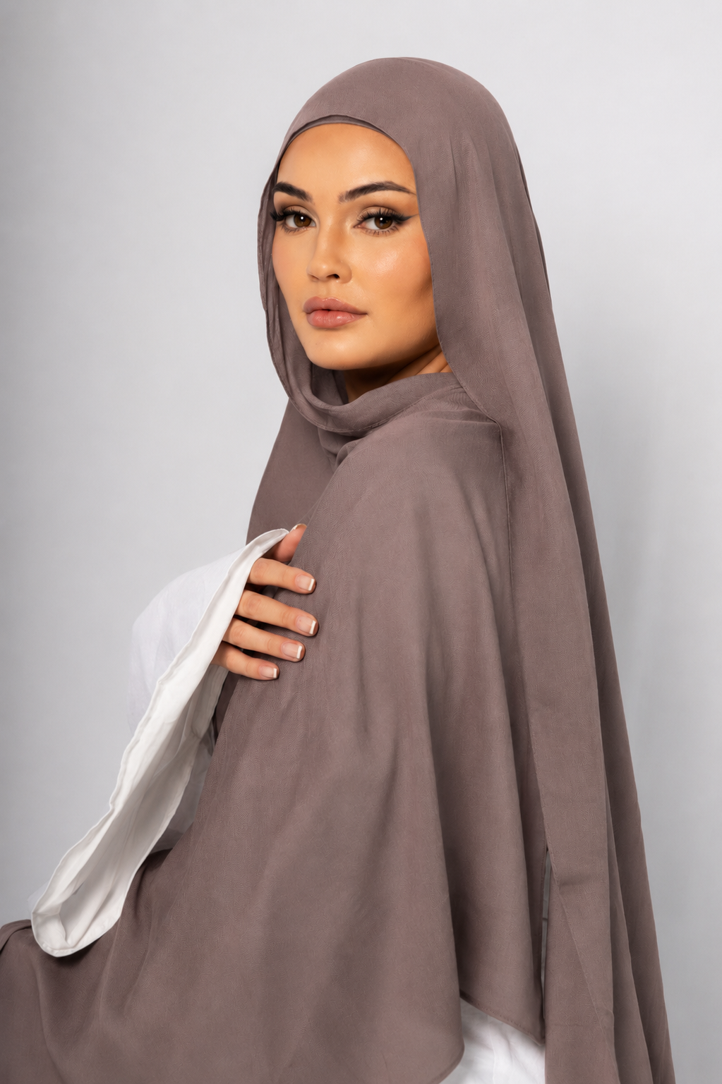 Back profile of a model wearing the Mauve Taupe modal hijab, highlighting its soft muted taupe shade, smooth drape, lightweight breathable fabric, and elegant modest styling