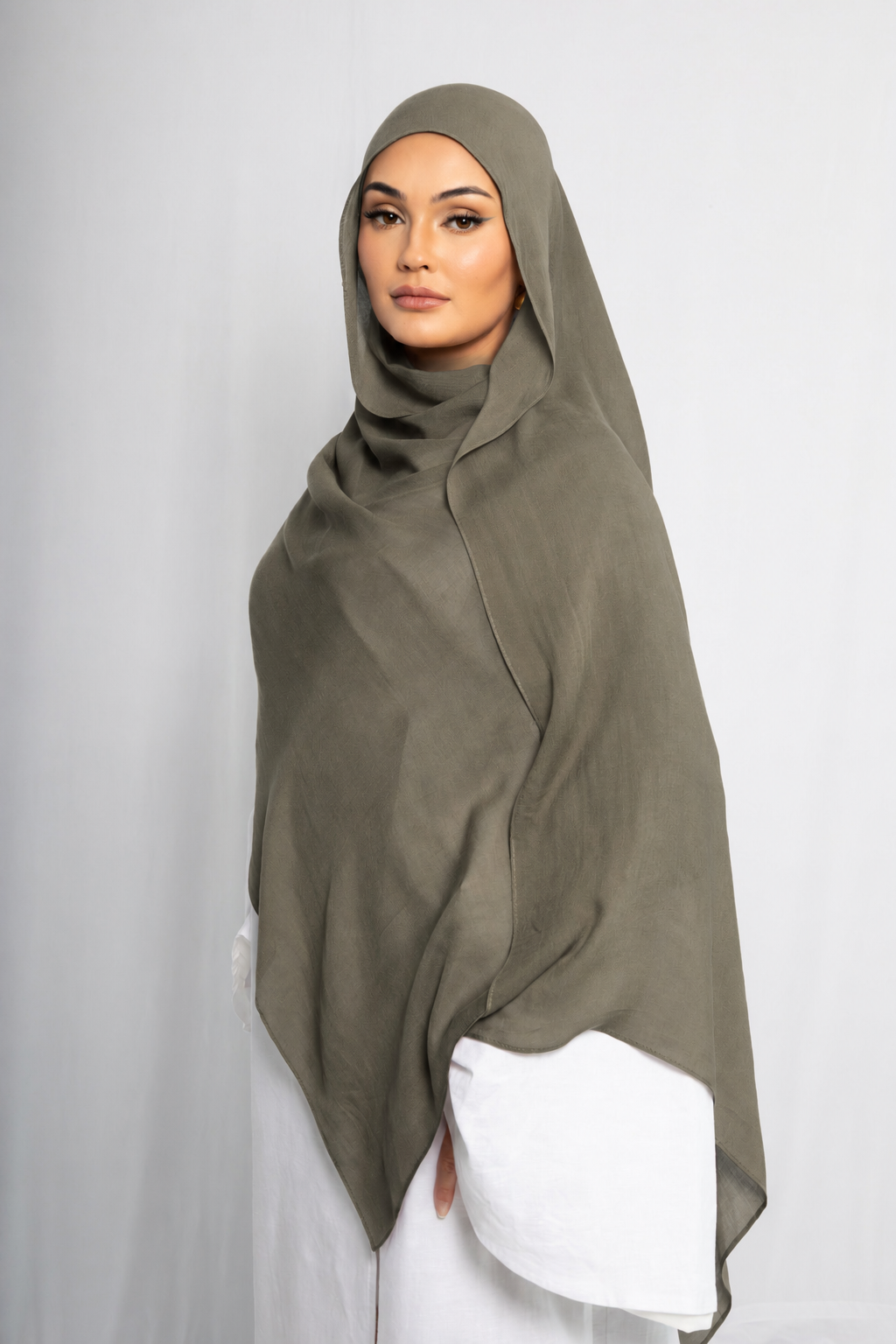Model wearing the Olive Grove modal hijab in a full-length front view, showcasing its earthy olive green shade, lightweight breathable modal fabric, elegant drape, and modest everyday styling