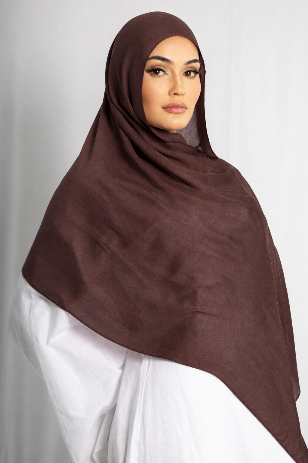 Front view of a woman wearing the Walnut Brown modal hijab, featuring a rich brown colour, lightweight breathable fabric, and an elegant draped style for modest wear